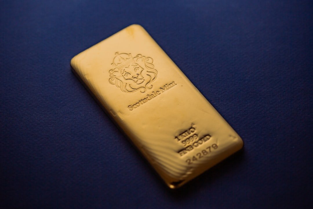 Scottsdale Mint 1 Kilo Gold Bullion Bars sitting on a simple textured backdrop. Each bar is pure 9999 Fine and made from gold precious metals. Please give a shoutout to Scottsdale Mint if able! Shop online for the most beautiful bullion at ScottsdaleMint.com!