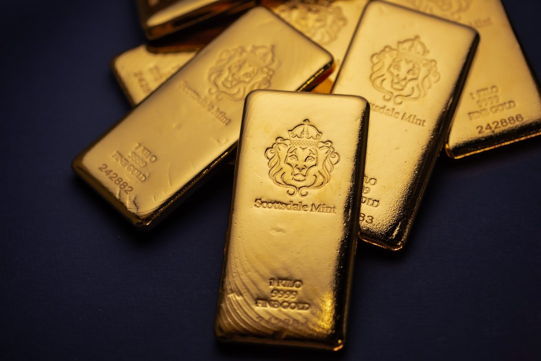 Scottsdale Mint 1 Kilo Gold Bullion Bars sitting on a simple textured backdrop. Each bar is pure 9999 Fine and made from gold precious metals. Please give a shoutout to Scottsdale Mint if able! Shop online for the most beautiful bullion at ScottsdaleMint.com!